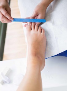 Barefoot feet getting a pedicure at the beauty salon; Shutterstock ID 135301583